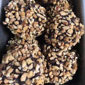 Chocolate cake and chocolate frosting, coated in dark chocolate and toasted peanuts