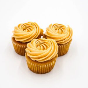 Vanilla cupcakes filled with caramel and topped with caramel buttercream and caramel pearls
