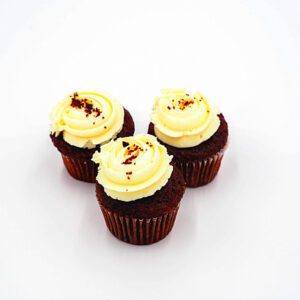 Our signature red velvet cupcakes are a crowd-pleaser! Each cupcake is topped with a decadent cream cheese frosting and finished with a touch of red velvet crumbs for an extra layer of flavor and texture.