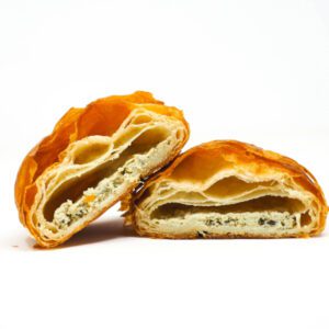Flaky layers of croissant dough envelop a creamy, herbed goat cheese filling, accented with fragrant basil.