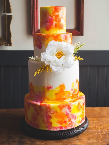 A fall cake with a gradient of colors, creating a beautiful and eye-catching effect.